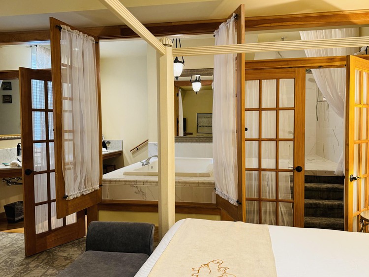 Bed in hotel room with French doors